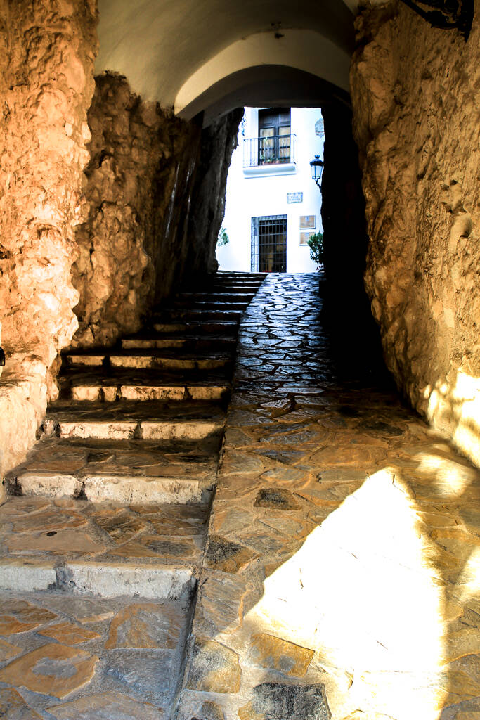 narrow passage and typical facade of polop village