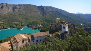 guadalest lake and village. reservoir and tiled roofs.