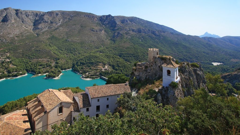 guadalest lake and village. reservoir and tiled roofs.